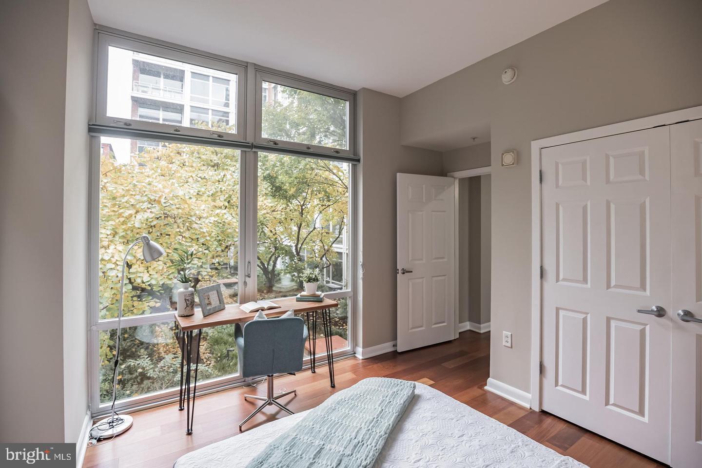 22 South Front Street, Unit 207 Philadelphia, PA 19106 - Photo 4 of 32 a bedroom with a bed and large window