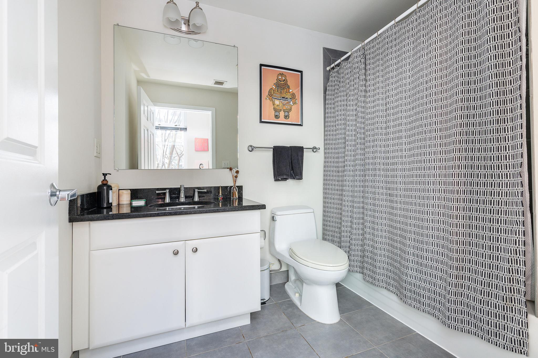 22 South Front Street, Unit 207 Philadelphia, PA 19106 - Photo 5 of 32 a bathroom with a toilet a sink and mirror