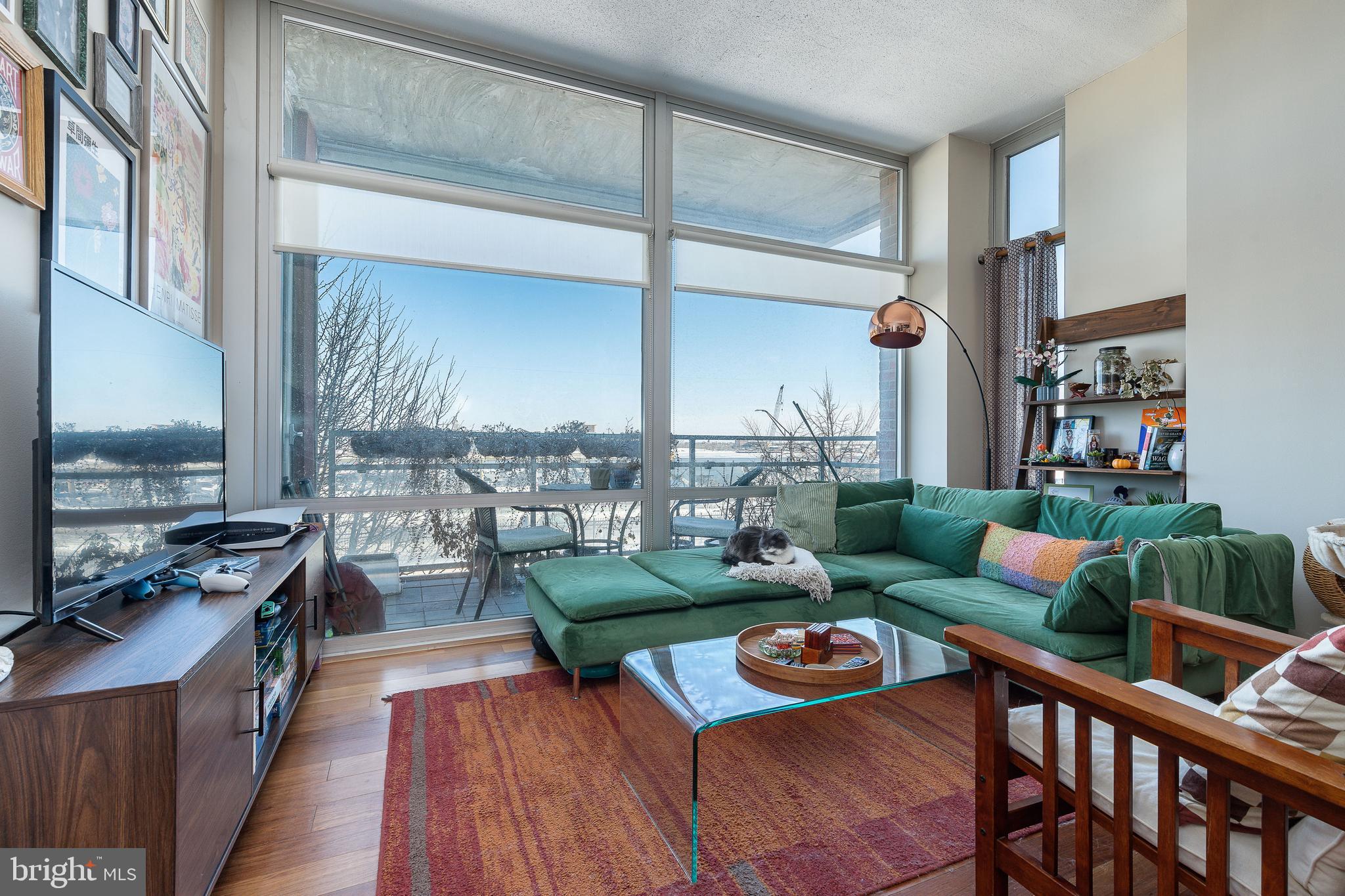 22 South Front Street, Unit 207 Philadelphia, PA 19106 - Photo 7 of 32 a living room with furniture and a wooden floor