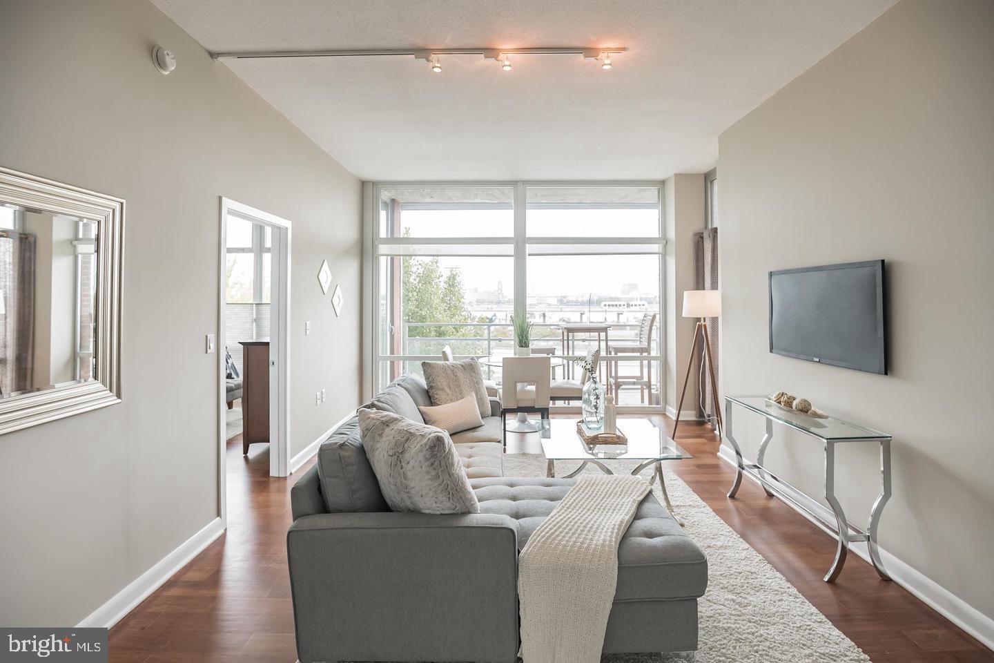 22 South Front Street, Unit 207 Philadelphia, PA 19106 - Photo 10 of 32 a living room with furniture and a flat screen tv