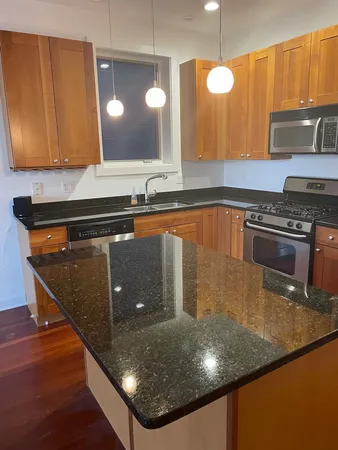 an empty room with windows & cabinet