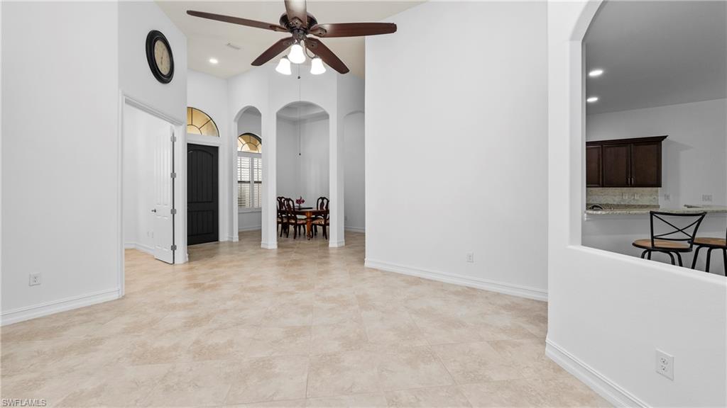 8856 Lely Island Circle Naples, FL 34113 - Photo 11 of 50 Spare room featuring arched walkways, ceiling fan, recessed lighting, and a high ceiling
