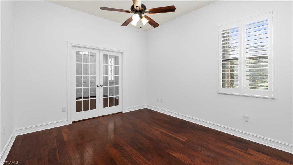 8856 Lely Island Circle Naples, FL 34113 - Photo 23 of 50 Spare room with french doors, a ceiling fan, and dark wood-style flooring