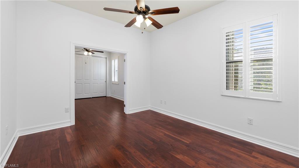 8856 Lely Island Circle Naples, FL 34113 - Photo 26 of 50 Empty room featuring dark wood-style floors and ceiling fan