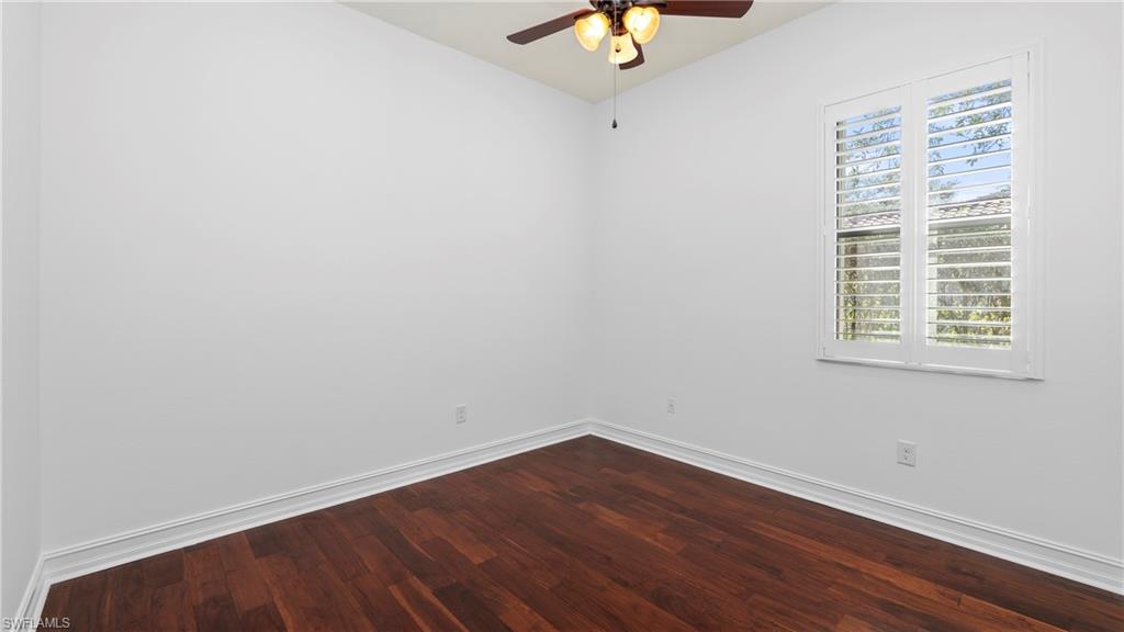 8856 Lely Island Circle Naples, FL 34113 - Photo 28 of 50 Empty room featuring ceiling fan and dark wood finished floors