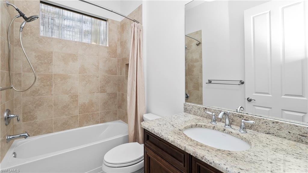 8856 Lely Island Circle Naples, FL 34113 - Photo 33 of 50 Bathroom featuring shower / bath combo and vanity