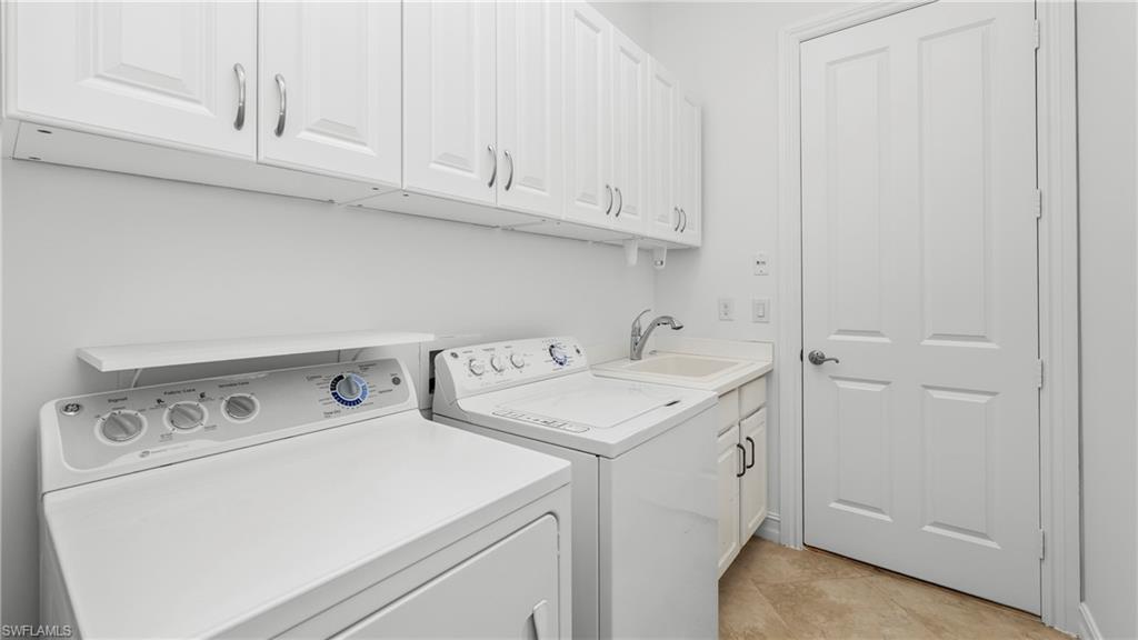 8856 Lely Island Circle Naples, FL 34113 - Photo 34 of 50 Laundry area with cabinet space and washer and dryer