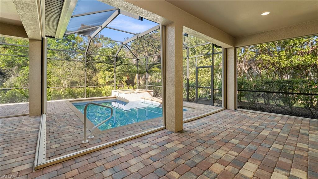 8856 Lely Island Circle Naples, FL 34113 - Photo 37 of 50 Relaxing pool / spa with a lanai, a patio, and a sunroom