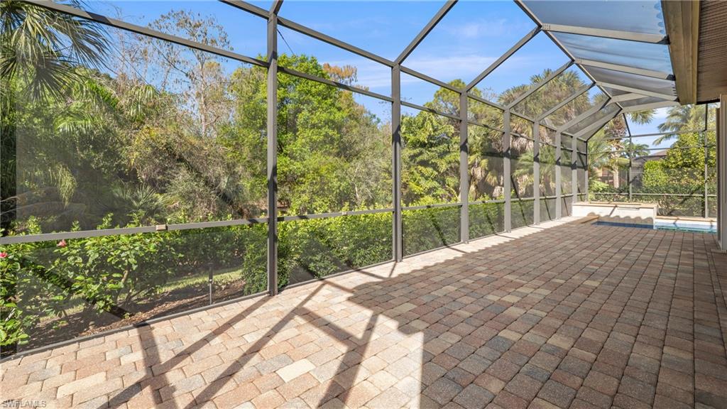 8856 Lely Island Circle Naples, FL 34113 - Photo 41 of 50 View of patio with a sunroom, glass enclosure, and a swimming pool