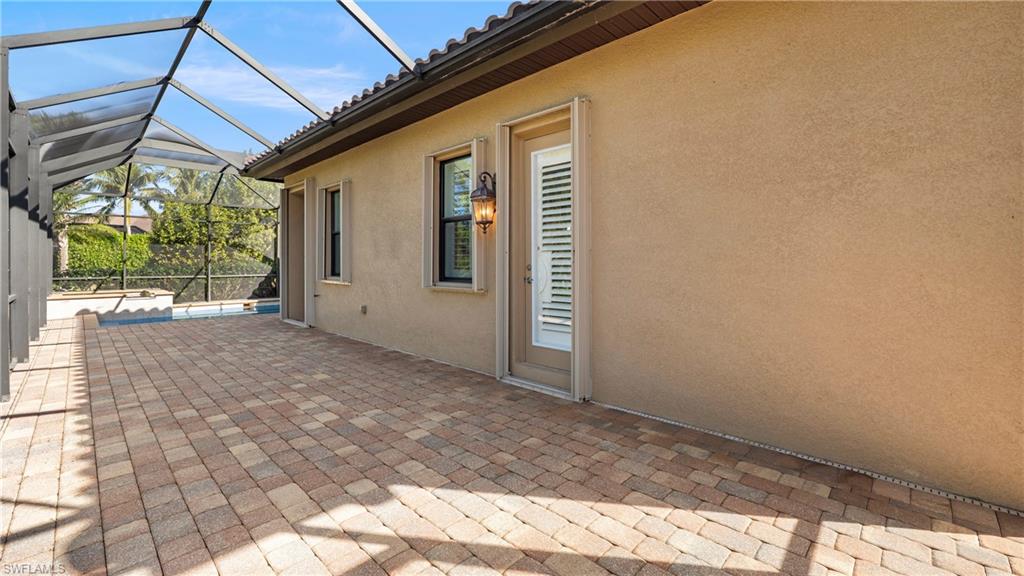 8856 Lely Island Circle Naples, FL 34113 - Photo 42 of 50 View of patio featuring a sunroom and glass enclosure