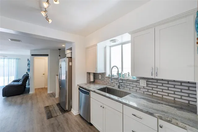a kitchen with a sink and cabinets