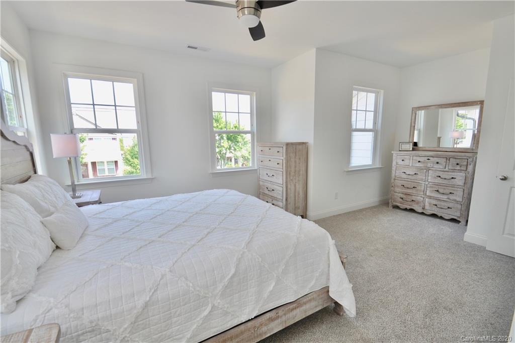 235 Keener Boulevard Belmont, NC 28012 - Photo 12 of 29 a spacious bedroom with a bed a dresser and windows