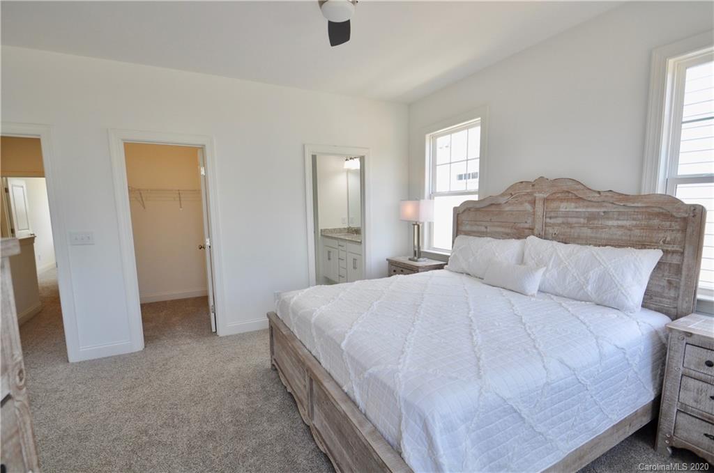 235 Keener Boulevard Belmont, NC 28012 - Photo 13 of 29 a bedroom with a bed and a large mirror