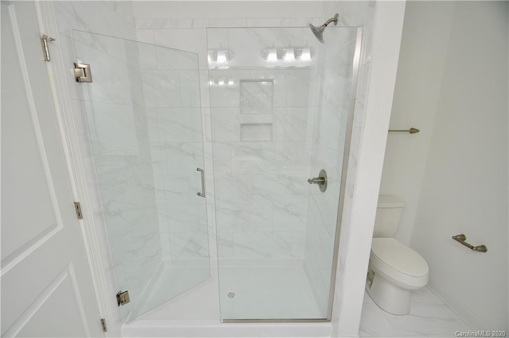 235 Keener Boulevard Belmont, NC 28012 - Photo 15 of 29 a bathroom with a shower a toilet and sink