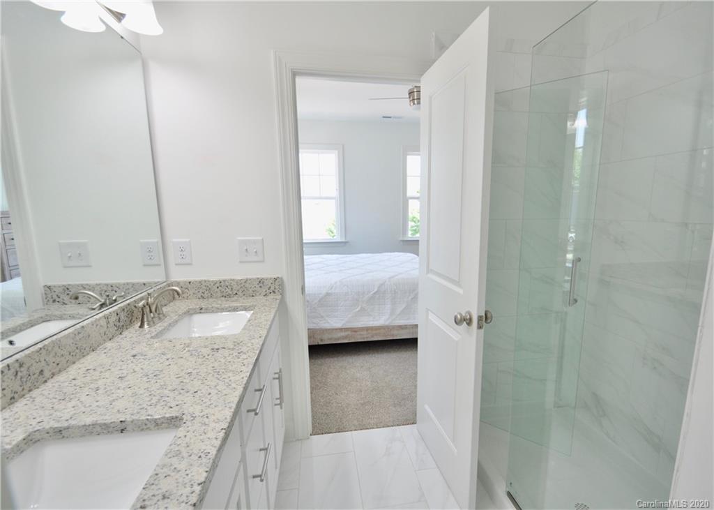 235 Keener Boulevard Belmont, NC 28012 - Photo 16 of 29 a bathroom with a granite countertop sink a mirror and shower