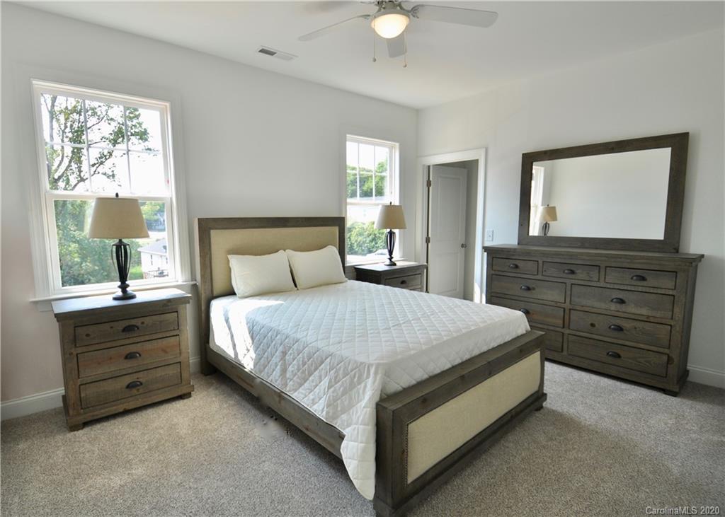 235 Keener Boulevard Belmont, NC 28012 - Photo 18 of 29 a bedroom with a bed and a dresser