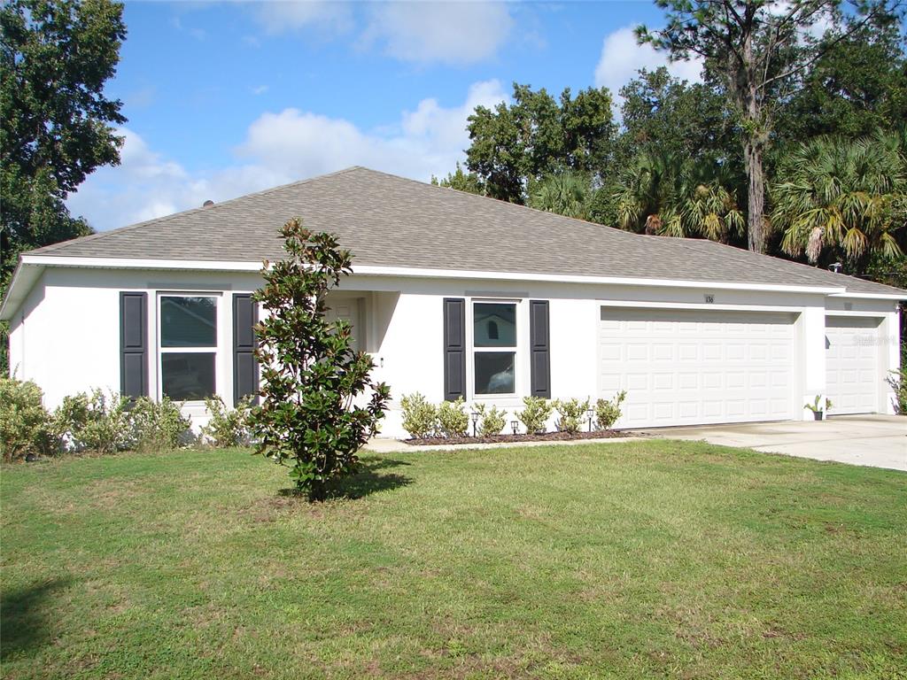 136 Sea Trail Palm Coast, FL 32164 - Photo 1 of 29 a front view of house with yard and green space