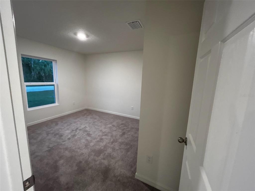 136 Sea Trail Palm Coast, FL 32164 - Photo 13 of 29 an empty room with a window