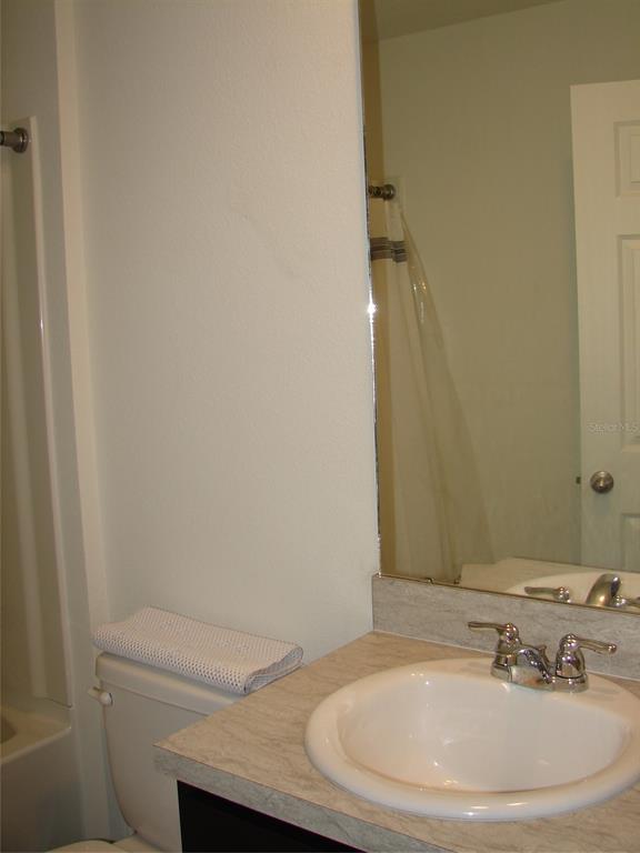 136 Sea Trail Palm Coast, FL 32164 - Photo 16 of 29 a bathroom with a granite countertop sink and a mirror