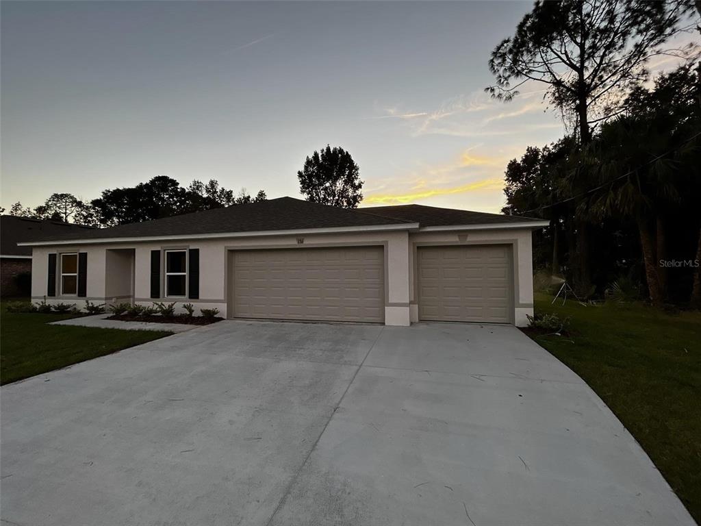 136 Sea Trail Palm Coast, FL 32164 - Photo 2 of 29 front view of a house with a garden