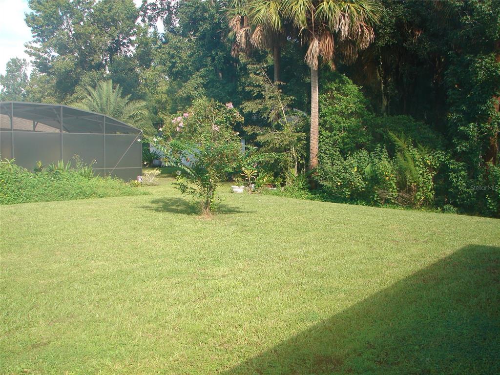 136 Sea Trail Palm Coast, FL 32164 - Photo 22 of 29 a swimming pool with outdoor seating and yard