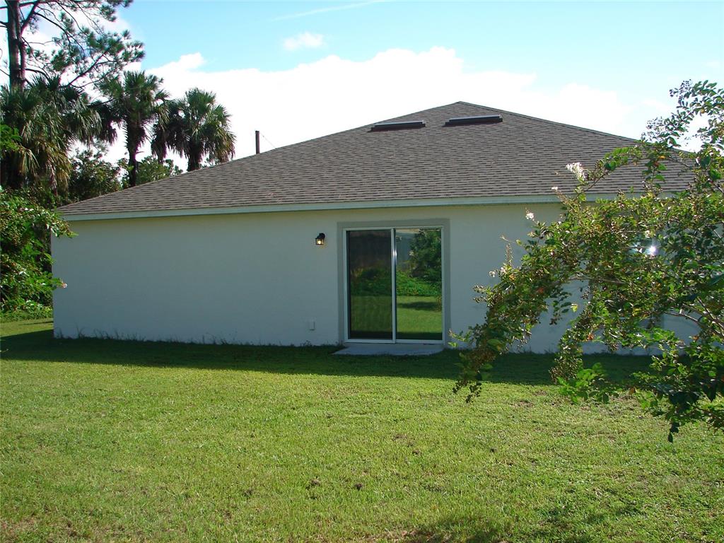 136 Sea Trail Palm Coast, FL 32164 - Photo 25 of 29 a front view of a house with a garden