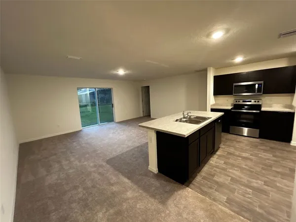 a kitchen with a stove a sink and a refrigerator