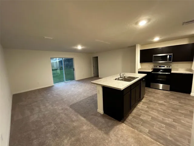 a kitchen with a stove a sink and a refrigerator