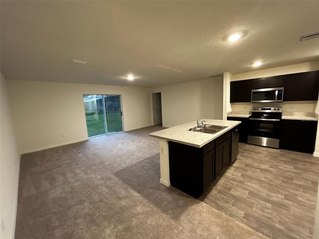 136 Sea Trail Palm Coast, FL 32164 - Photo 5 of 29 a kitchen with a stove a sink and a refrigerator