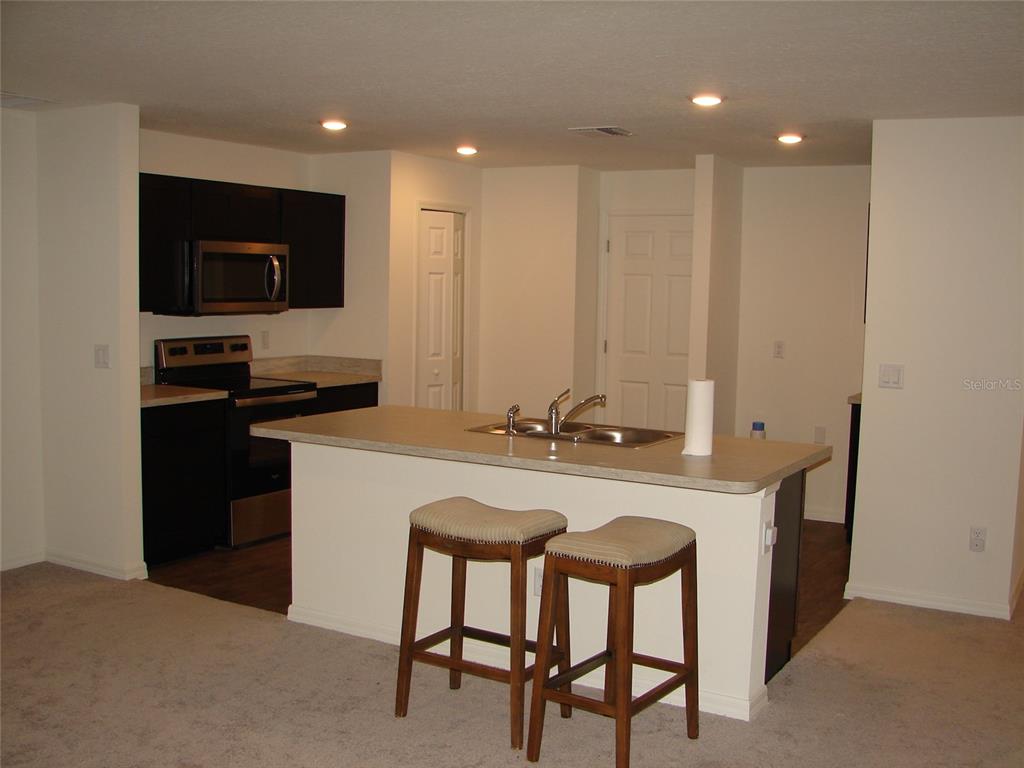 136 Sea Trail Palm Coast, FL 32164 - Photo 7 of 29 a kitchen with a table and chairs