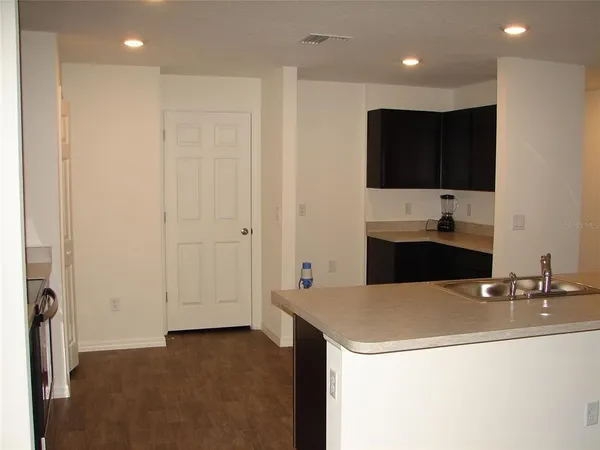 a kitchen with a sink and a refrigerator