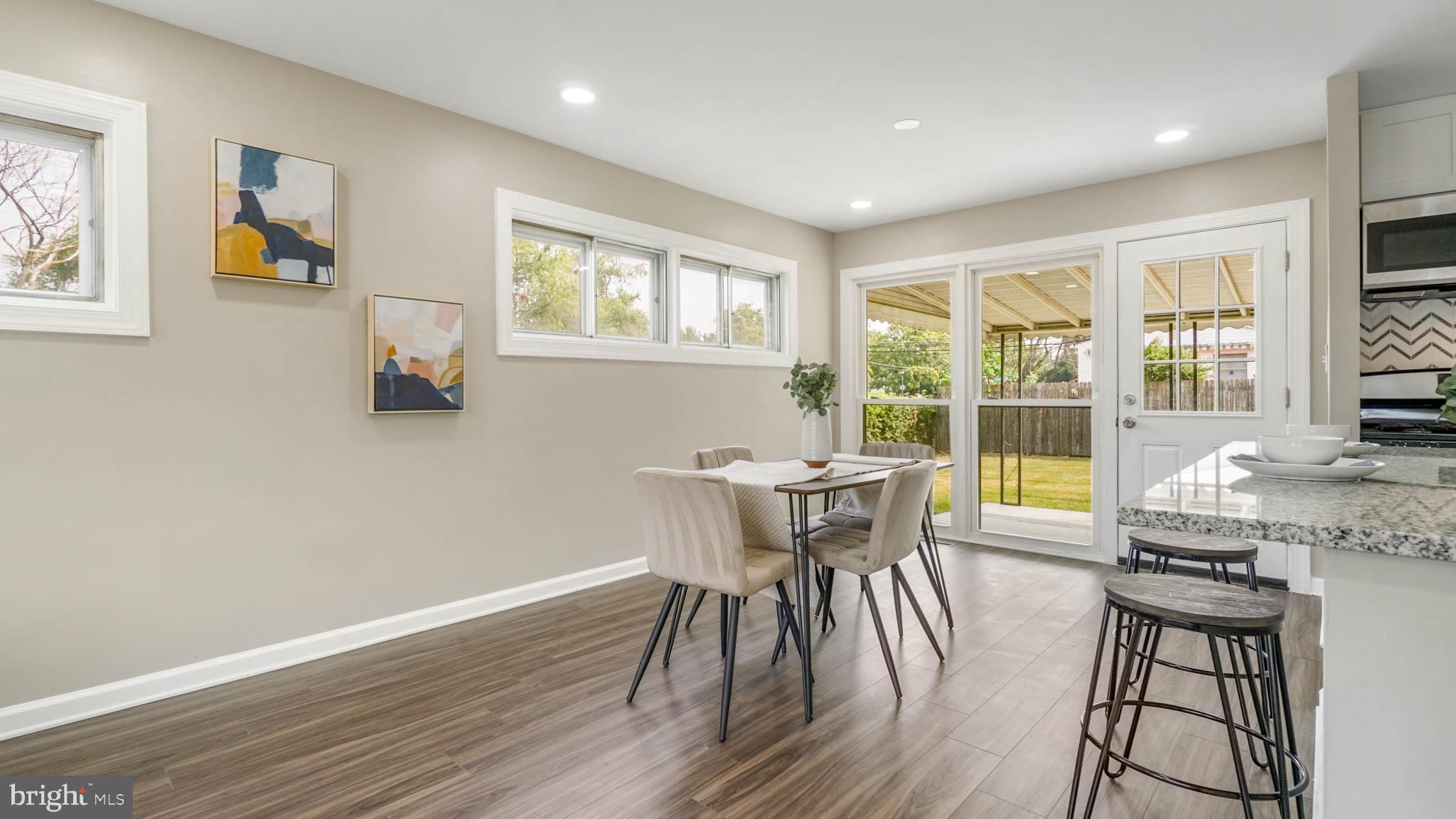5932 Charnwood Road Baltimore, MD 21228 - Photo 6 of 21 a view of a dining room with furniture a chandelier and wooden floor