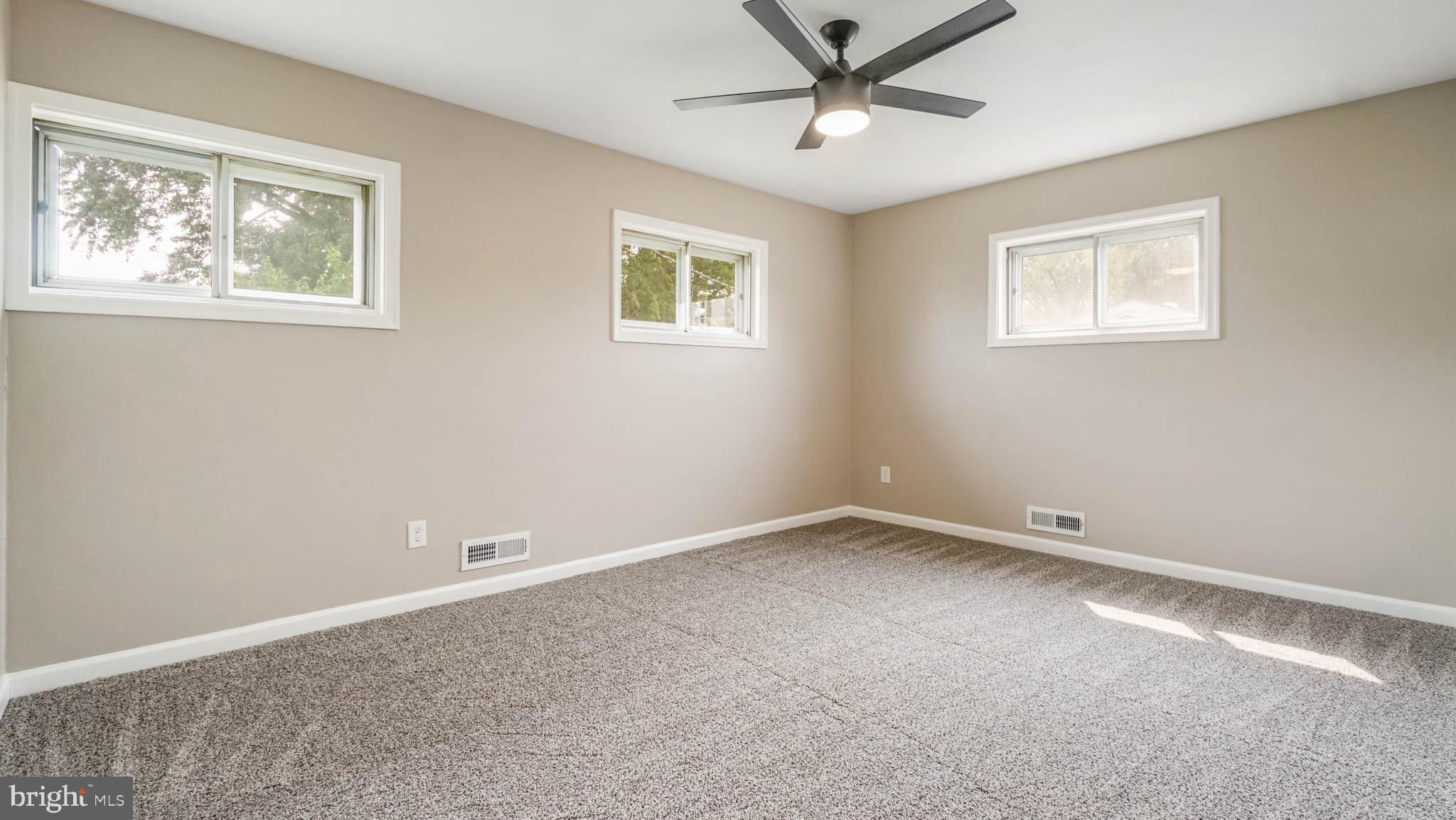5932 Charnwood Road Baltimore, MD 21228 - Photo 8 of 21 a view of an empty room with a window