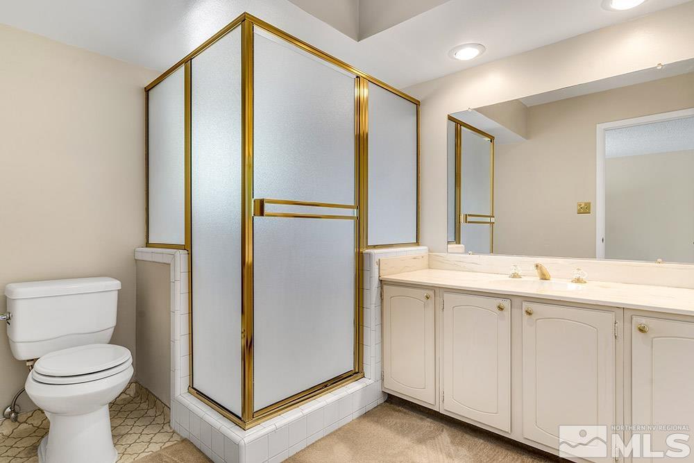 2120 Dant Boulevard Reno, NV 89509 - Photo 17 of 33 a bathroom with a sink a toilet and a mirror