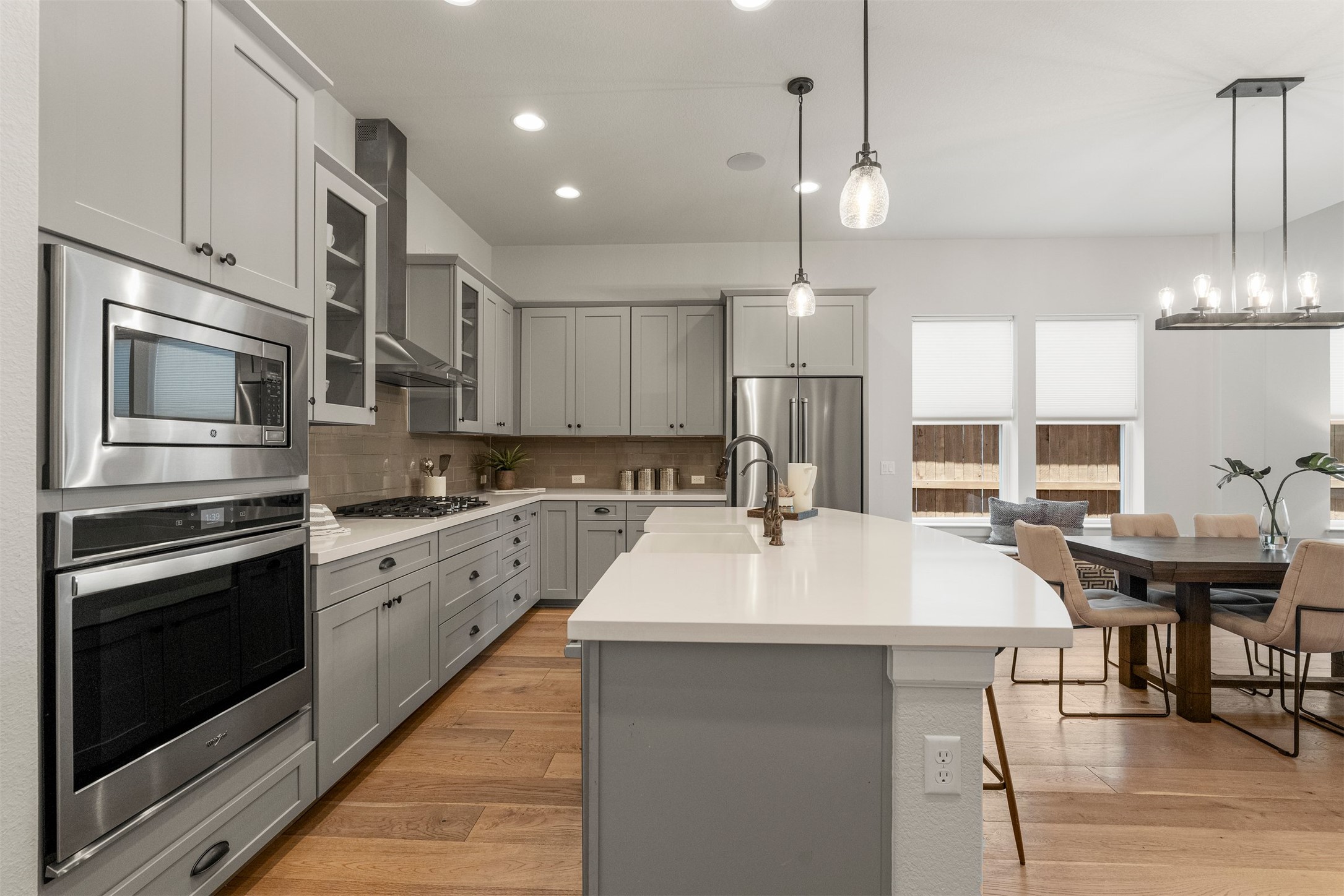 4313 Vaughan Street Austin, TX 78723 - Photo 7 of 39 The open-concept kitchen serves as the central hub downstairs, outfitted with quartz countertops that match the classic subway tile backsplash