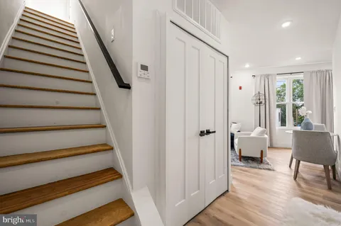 a view of entryway and hall with wooden floor