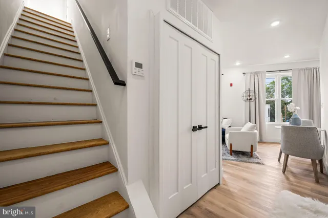 a view of entryway and hall with wooden floor