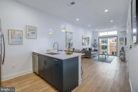 a kitchen with counter space and wooden floor