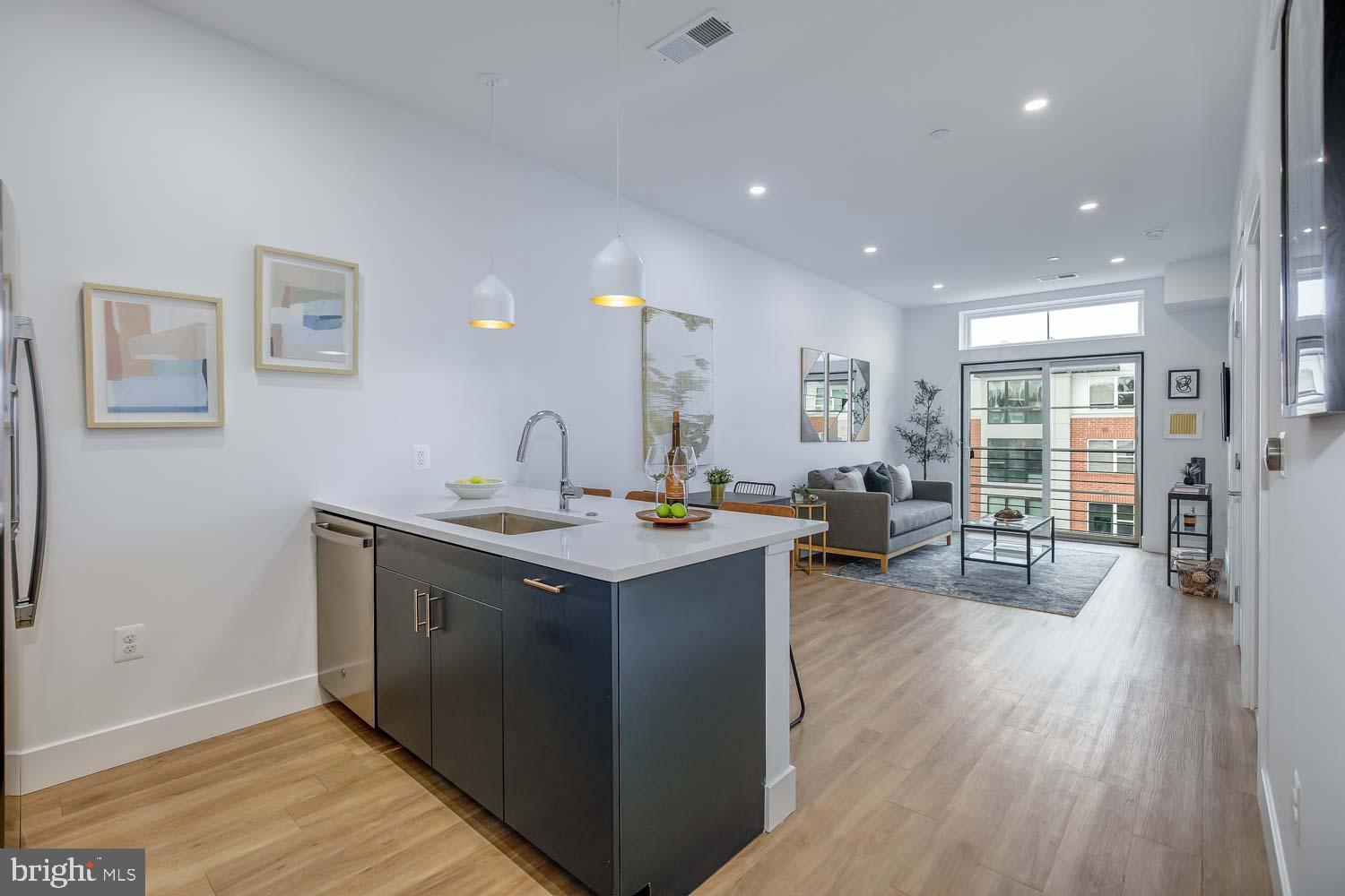 2310 4th Street Northeast, Unit 422 Washington, DC 20002 - Photo 1 of 18 a kitchen with counter space and wooden floor