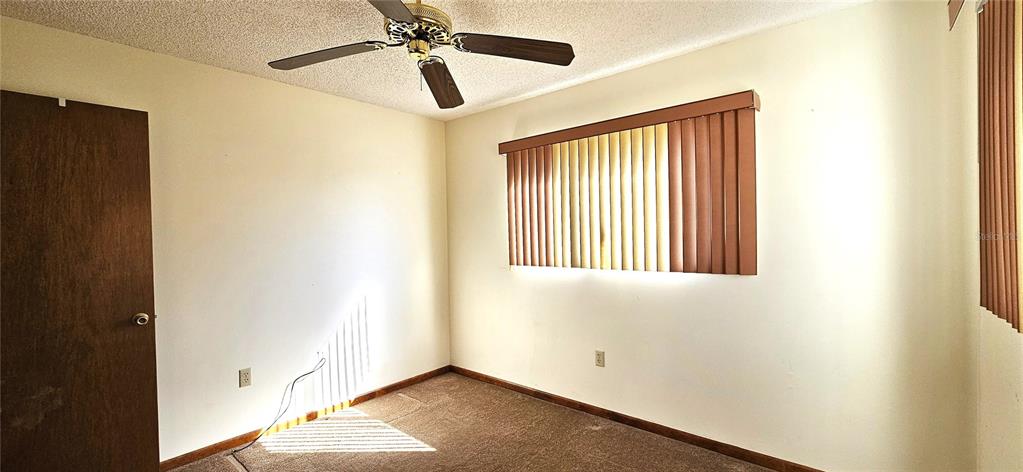 10838 Southwest 78th Court Ocala, FL 34476 - Photo 16 of 32 a view of a room with a window and ceiling fan