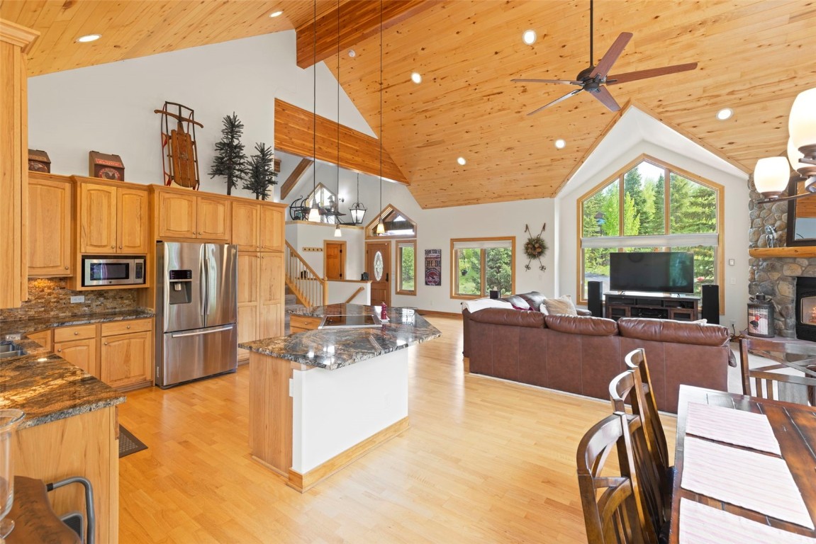 736 Wild Rose Road Silverthorne, CO 80498 - Photo 12 of 49 a living room with furniture a flat screen tv and a refrigerator