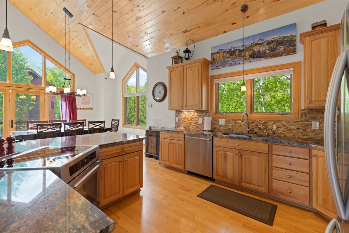 736 Wild Rose Road Silverthorne, CO 80498 - Photo 16 of 49 a large kitchen with kitchen island a large window in it