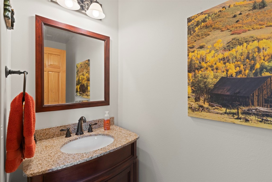 736 Wild Rose Road Silverthorne, CO 80498 - Photo 18 of 49 a bathroom with a granite countertop sink and a mirror