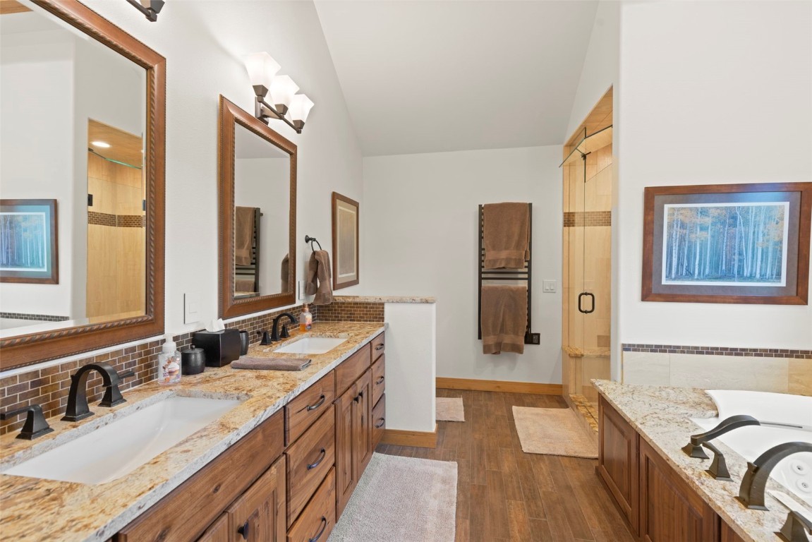 736 Wild Rose Road Silverthorne, CO 80498 - Photo 28 of 49 a bathroom with a granite countertop double vanity sink a mirror and a shower