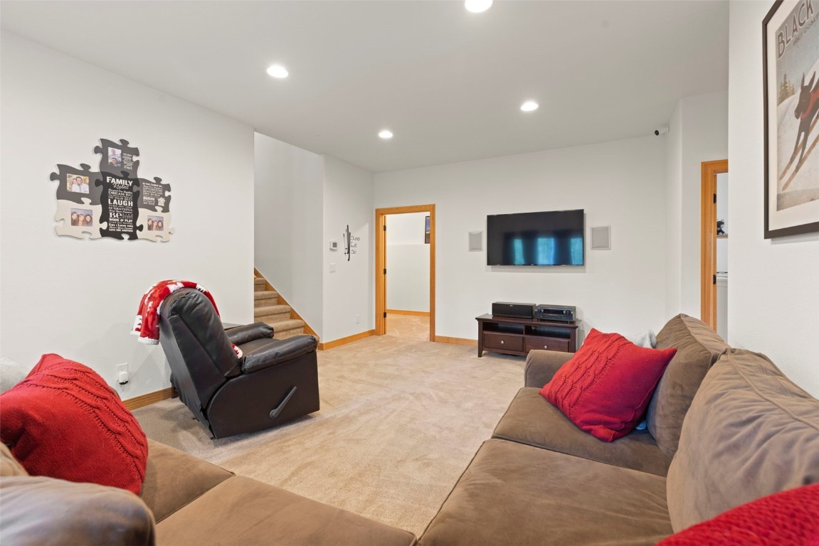 736 Wild Rose Road Silverthorne, CO 80498 - Photo 36 of 49 a living room with furniture and a flat screen tv