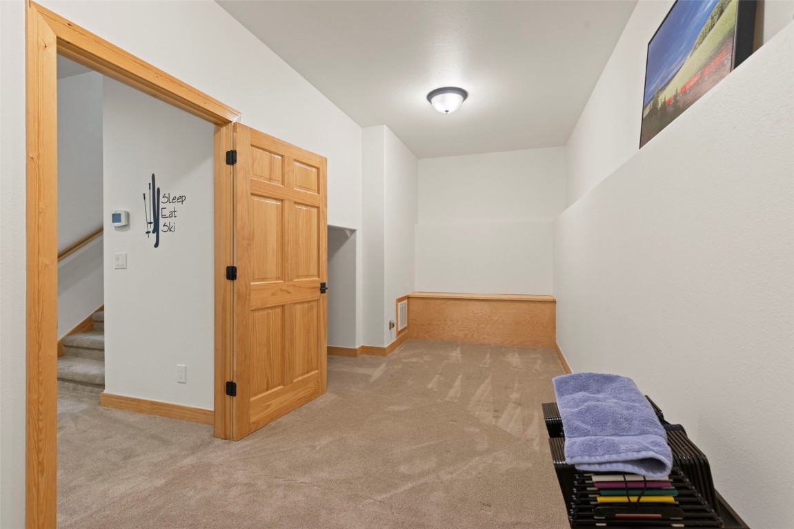 736 Wild Rose Road Silverthorne, CO 80498 - Photo 38 of 49 a bedroom with a bed and a cabinets