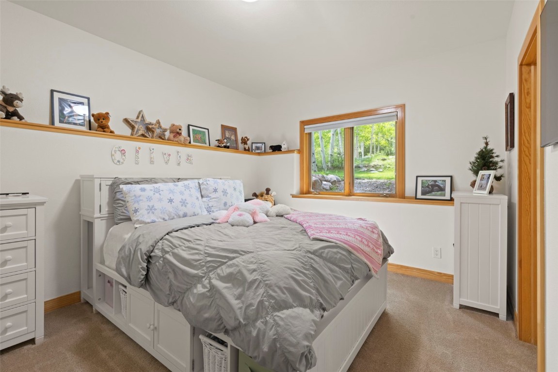 736 Wild Rose Road Silverthorne, CO 80498 - Photo 39 of 49 a bedroom with a bed and a window