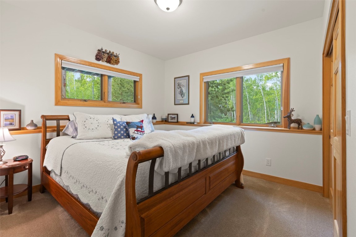 736 Wild Rose Road Silverthorne, CO 80498 - Photo 42 of 49 a bedroom with a bed and a large window