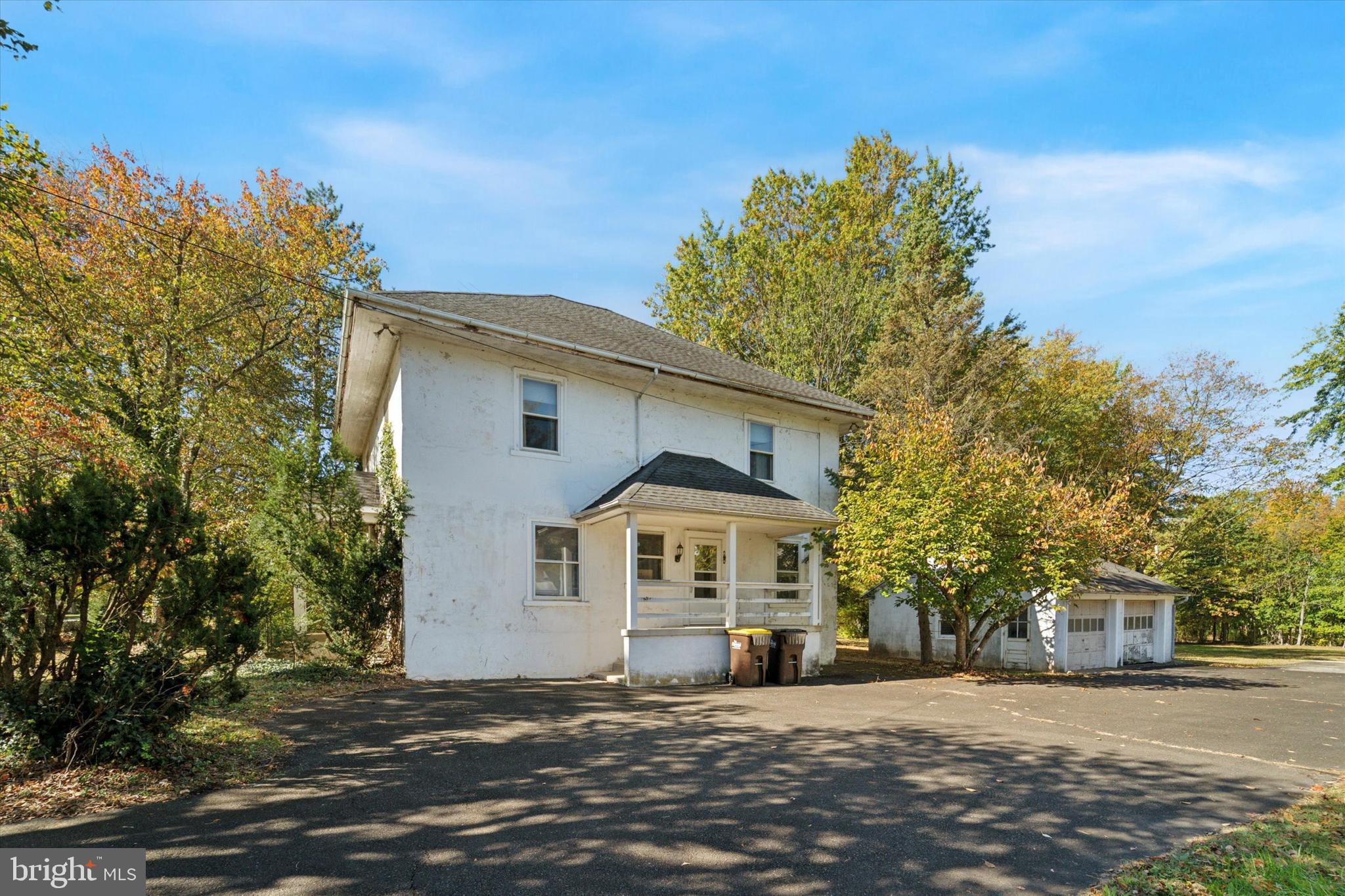 2546 North Broad Street Colmar, PA 19446 - Photo 23 of 25 a front view of a house with a dirt road and trees