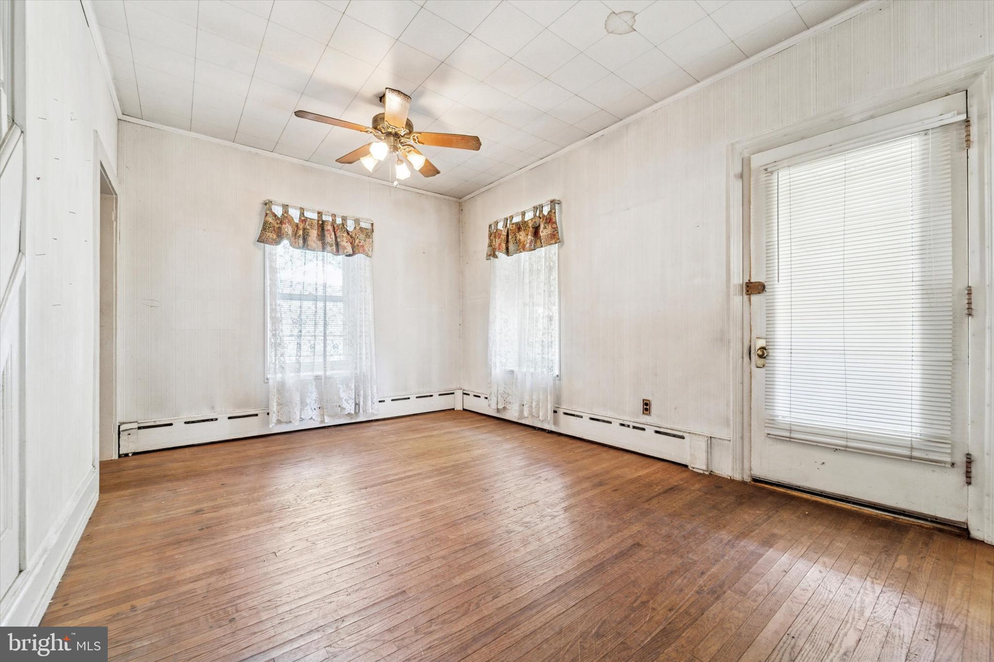2546 North Broad Street Colmar, PA 19446 - Photo 3 of 25 an empty room with wooden floor fan and windows